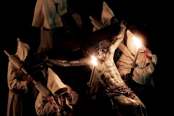 1 In Pictures Holy Week Penitents carry a figure of Christ on the cross